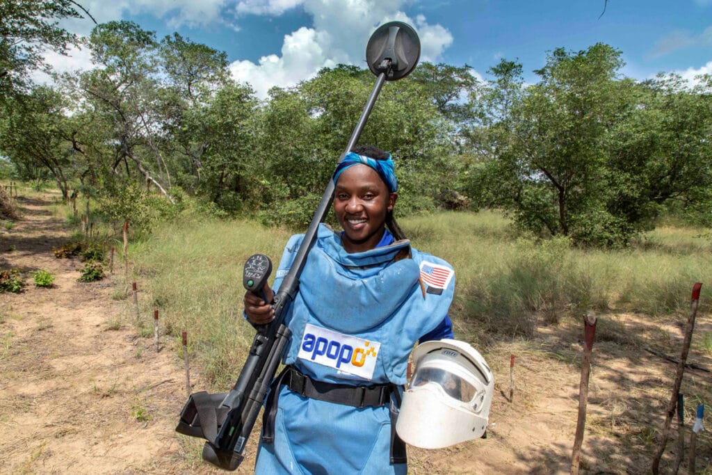 Marlin APOPO Deminer holding helmet and metal detector, MA Zimbabwe